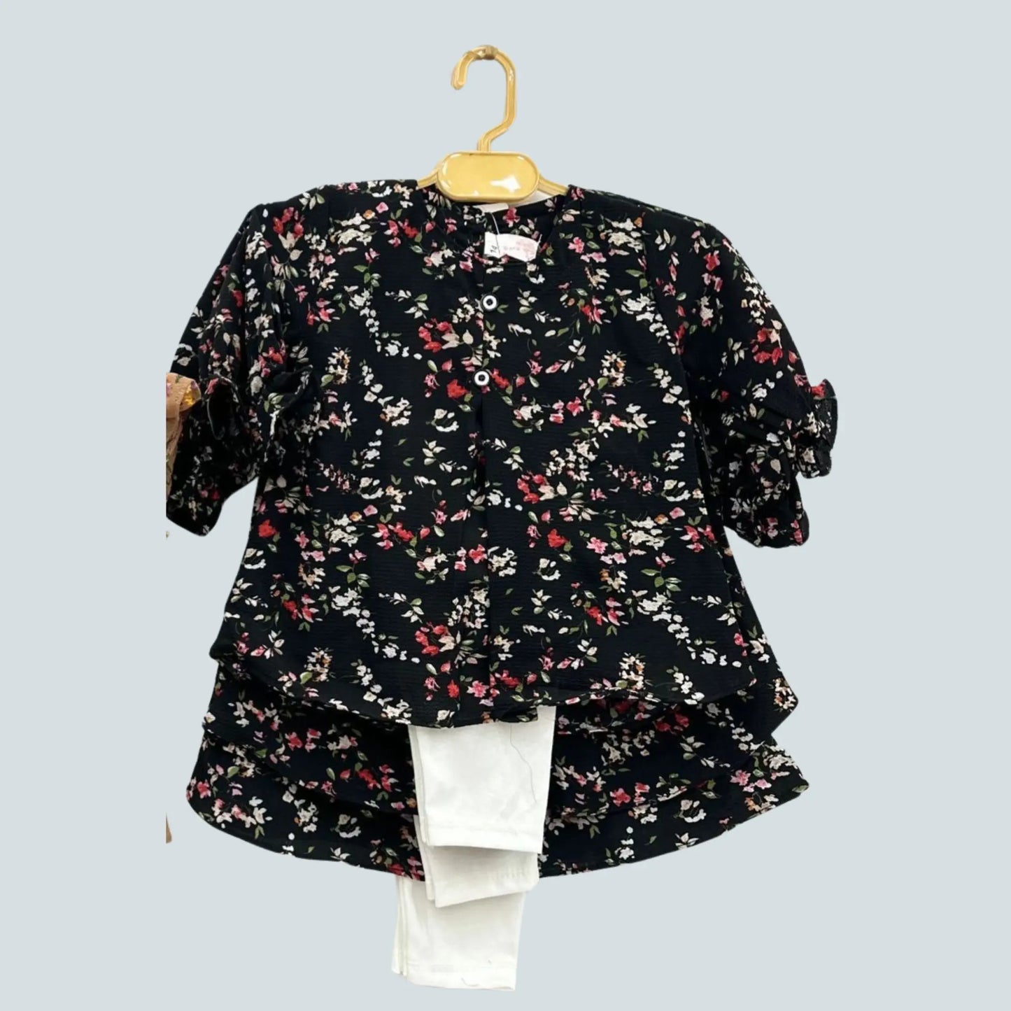 Floral blouse on a hanger against a light blue background
