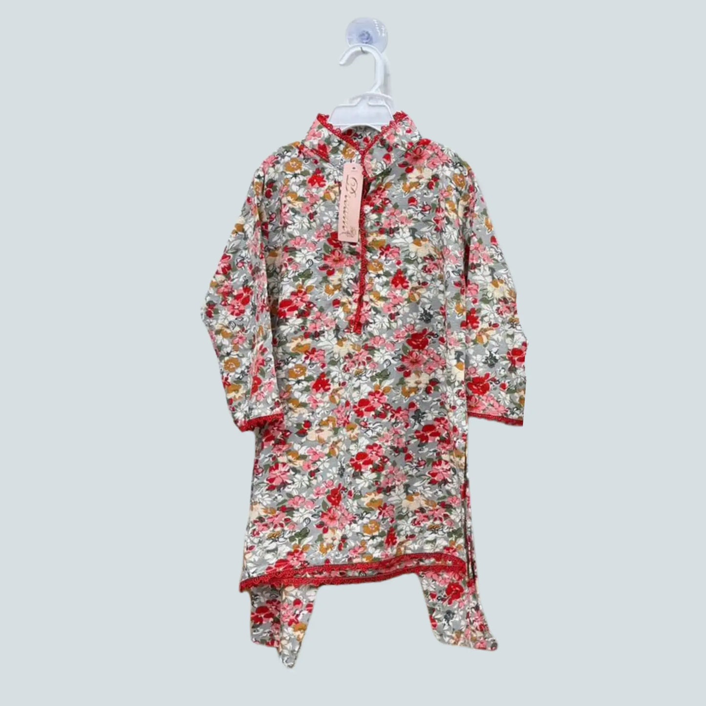 Floral dress on a hanger against a light gray background