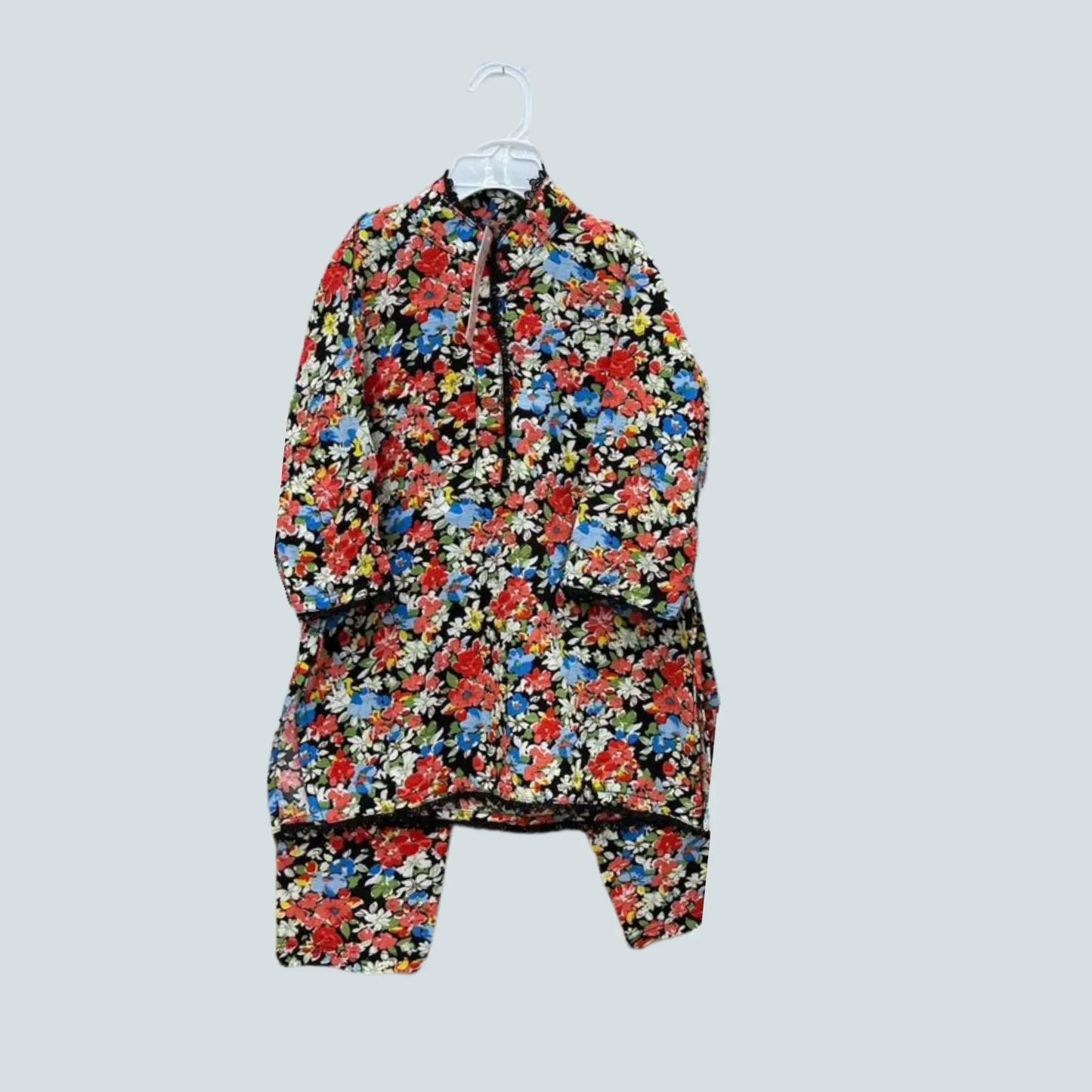 Floral patterned jacket on a hanger against a light gray background