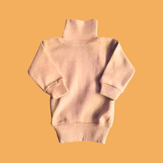 Beige sweater on a mustard yellow background