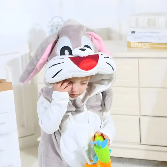 Child wearing a cartoon character onesie with bunny ears in a room.
