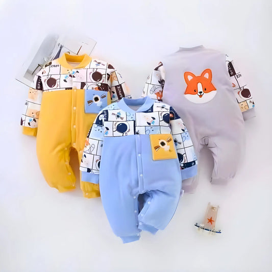 Three baby rompers in yellow, blue, and gray with cartoon designs on a white background