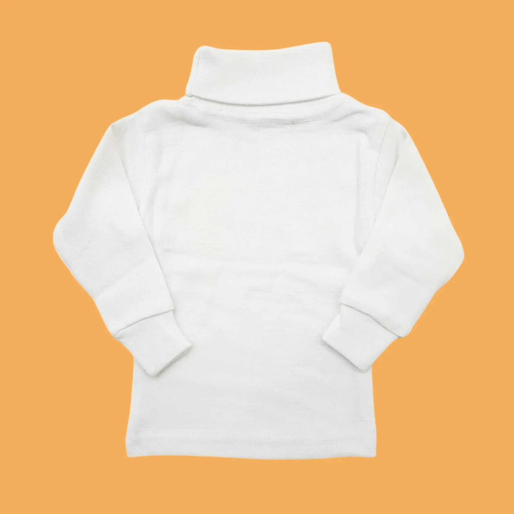 White turtleneck sweater on an orange background
