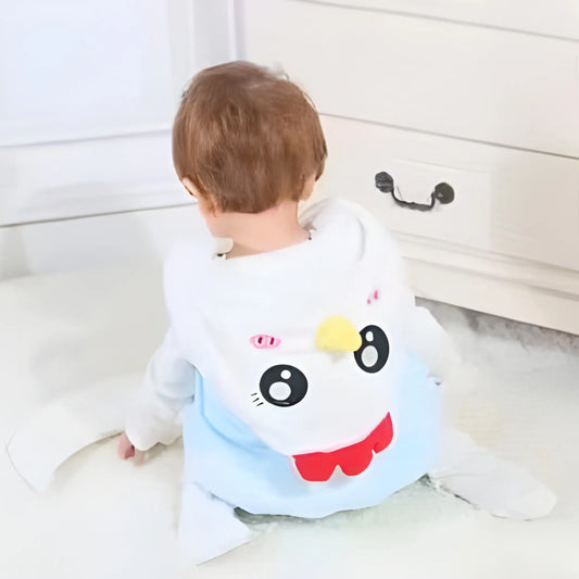Child wearing a cartoon character backpack in a room with white furniture.