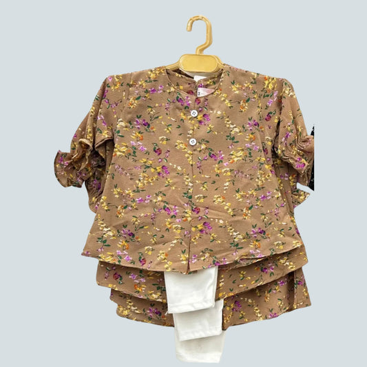 Floral patterned outfit on a hanger against a light gray background