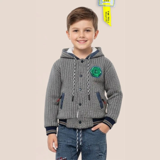 Child wearing a gray hooded jacket with a green patch on a beige background