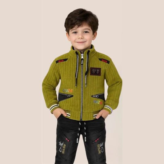 Child wearing a green jacket with black pants on a beige background