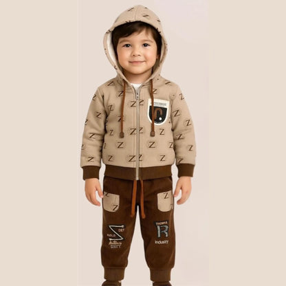 Child wearing a beige and brown outfit with a hood on a beige background